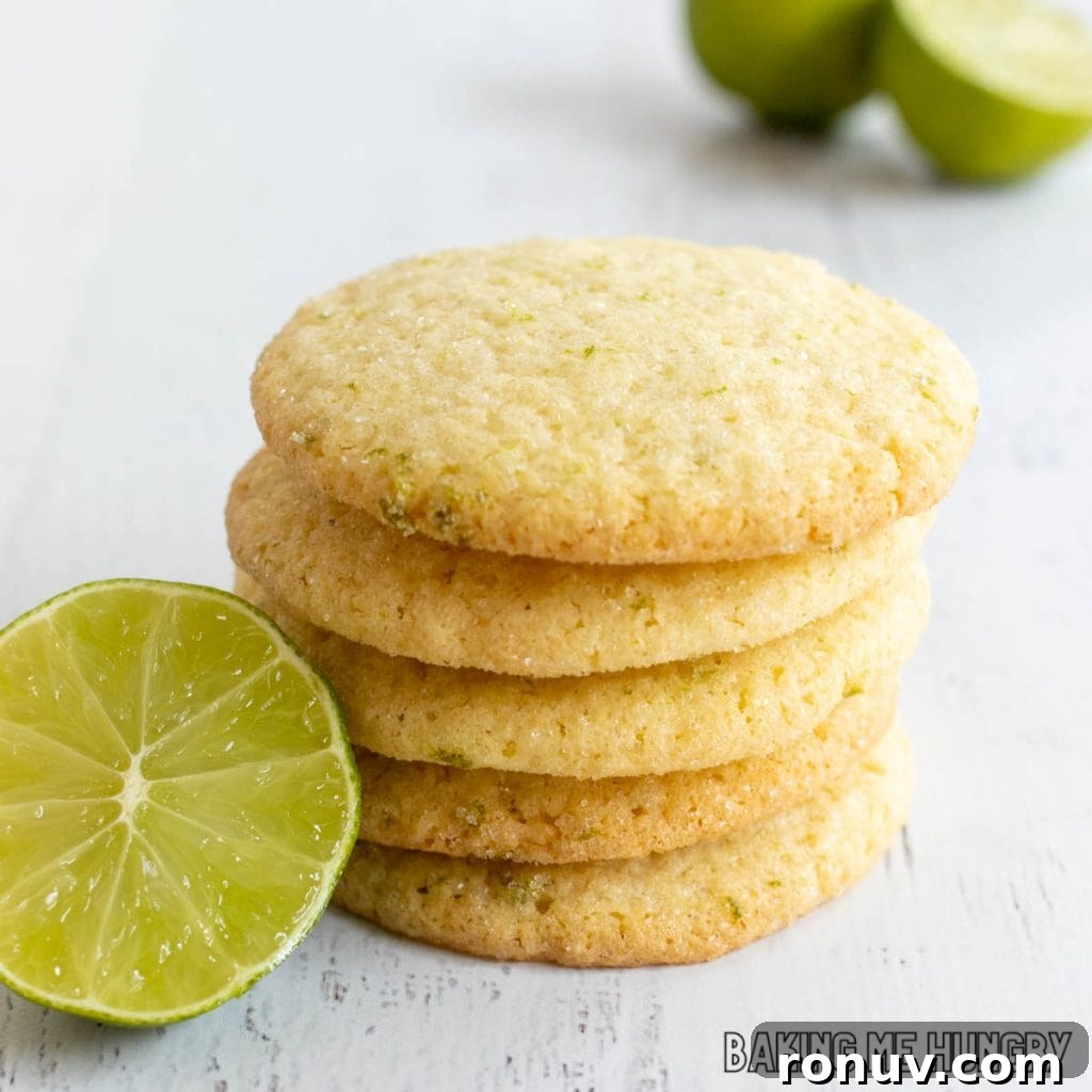 Zesty Lime Sugar Cookies with Citrus Glaze 2 lime sugar cookies in a stack next to halved lime