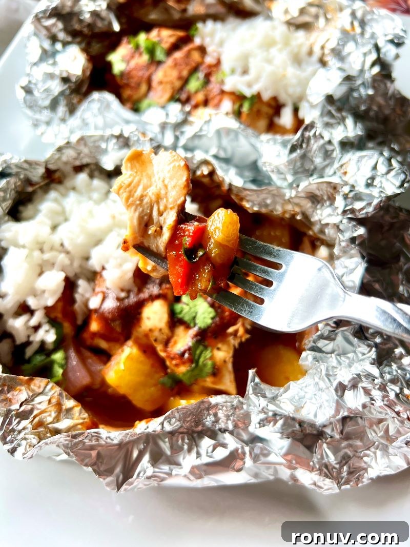 Grilled Pineapple BBQ Chicken Foil Packets 8 Finished pineapple BBQ chicken foil pack on a plate