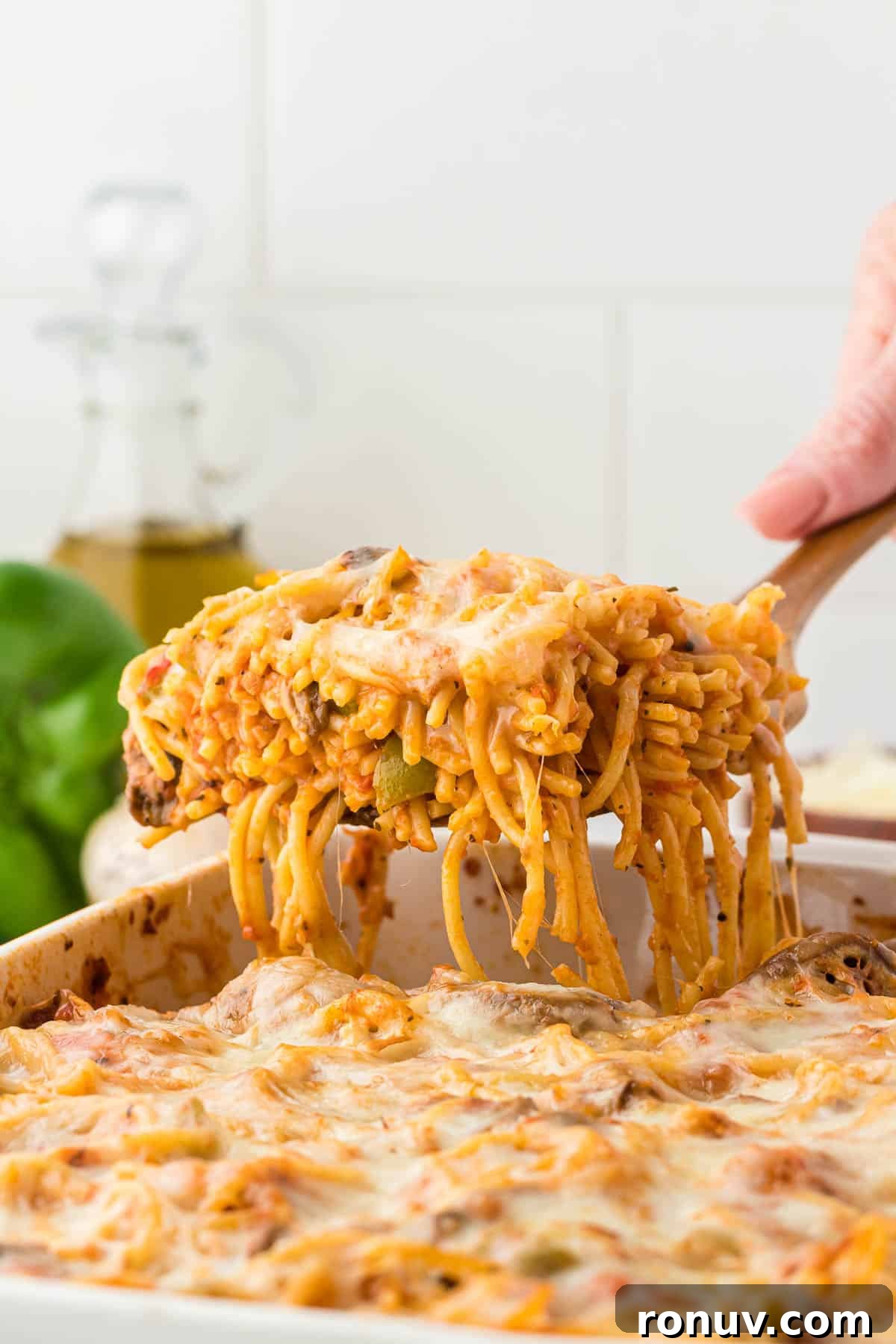 taking a serving of spaghetti bake from the dish