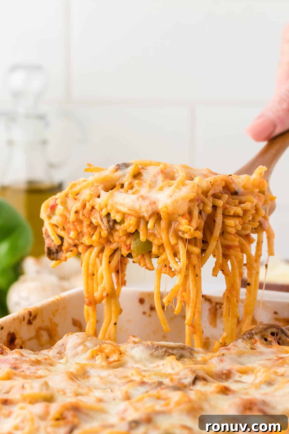 taking a serving of spaghetti bake from the dish
