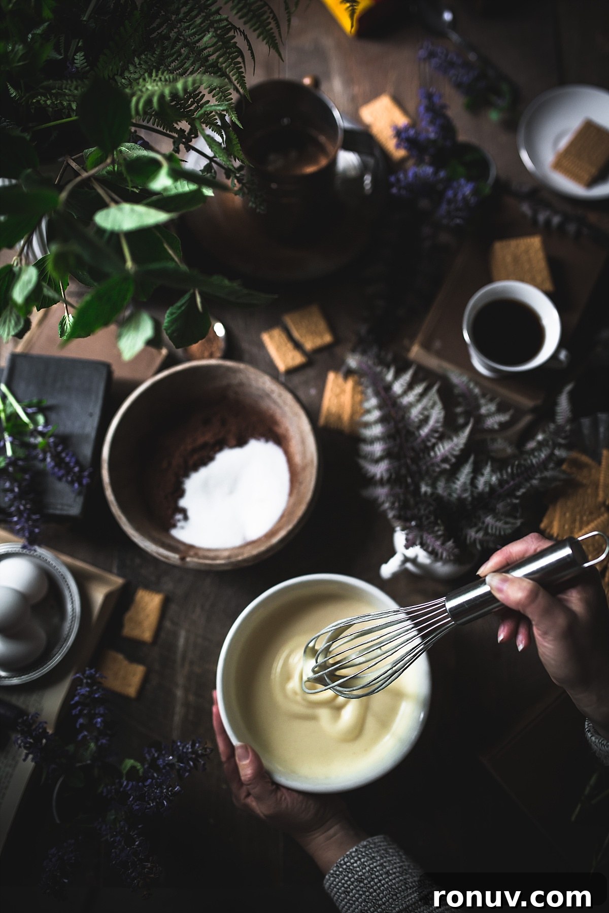 Kalter Hund Recipe: German No-Bake Layered Chocolate Cookie Cake 5 Flatlay shot of woman whipping eggs to make them frothy for Kalter Hund.