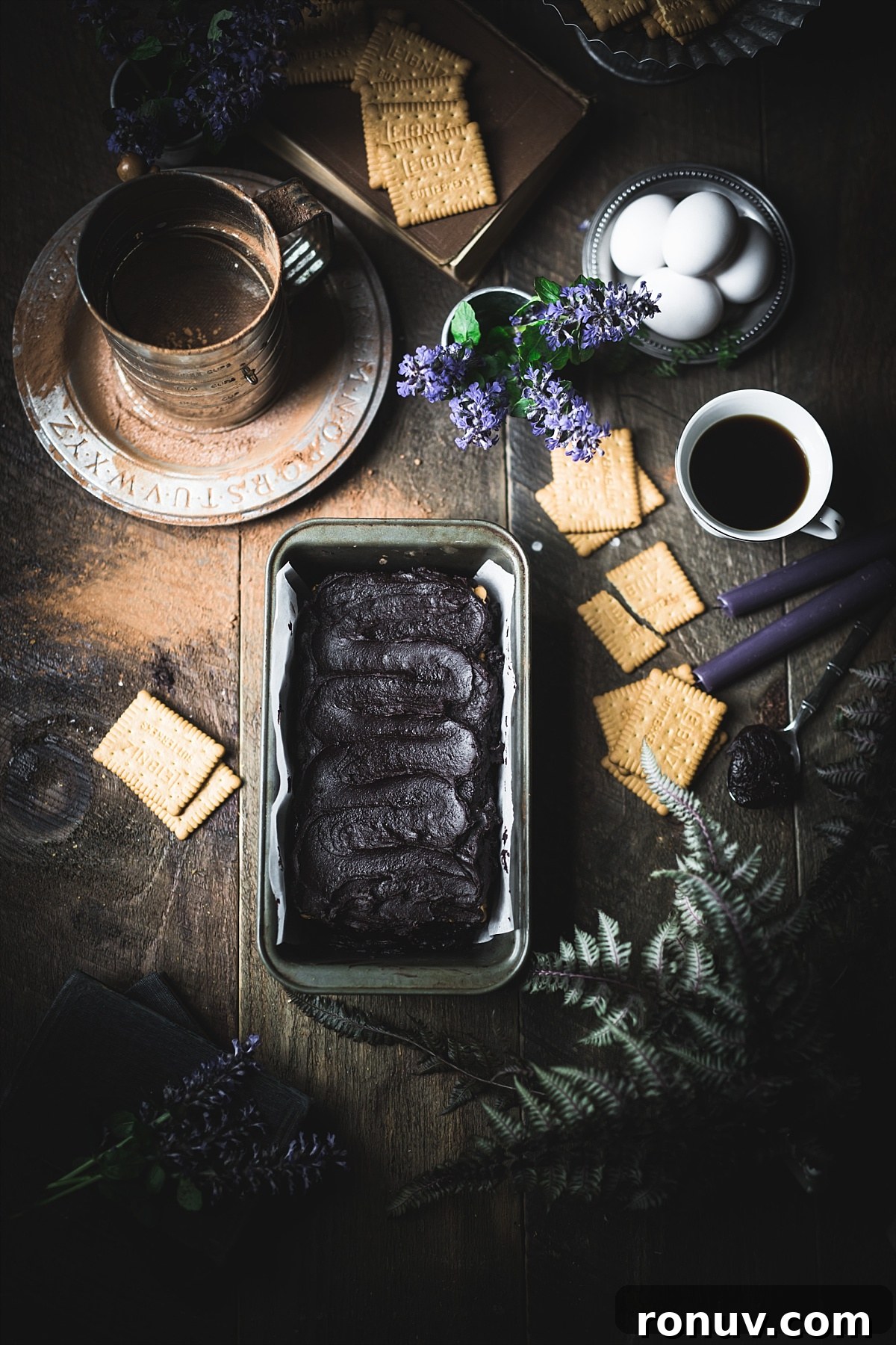 Kalter Hund Recipe: German No-Bake Layered Chocolate Cookie Cake 8 An overhead shot of a Kalter Hund no bake cake ready to put in fridge surrounded by Leibniz cookies and other ingredients from the cake.