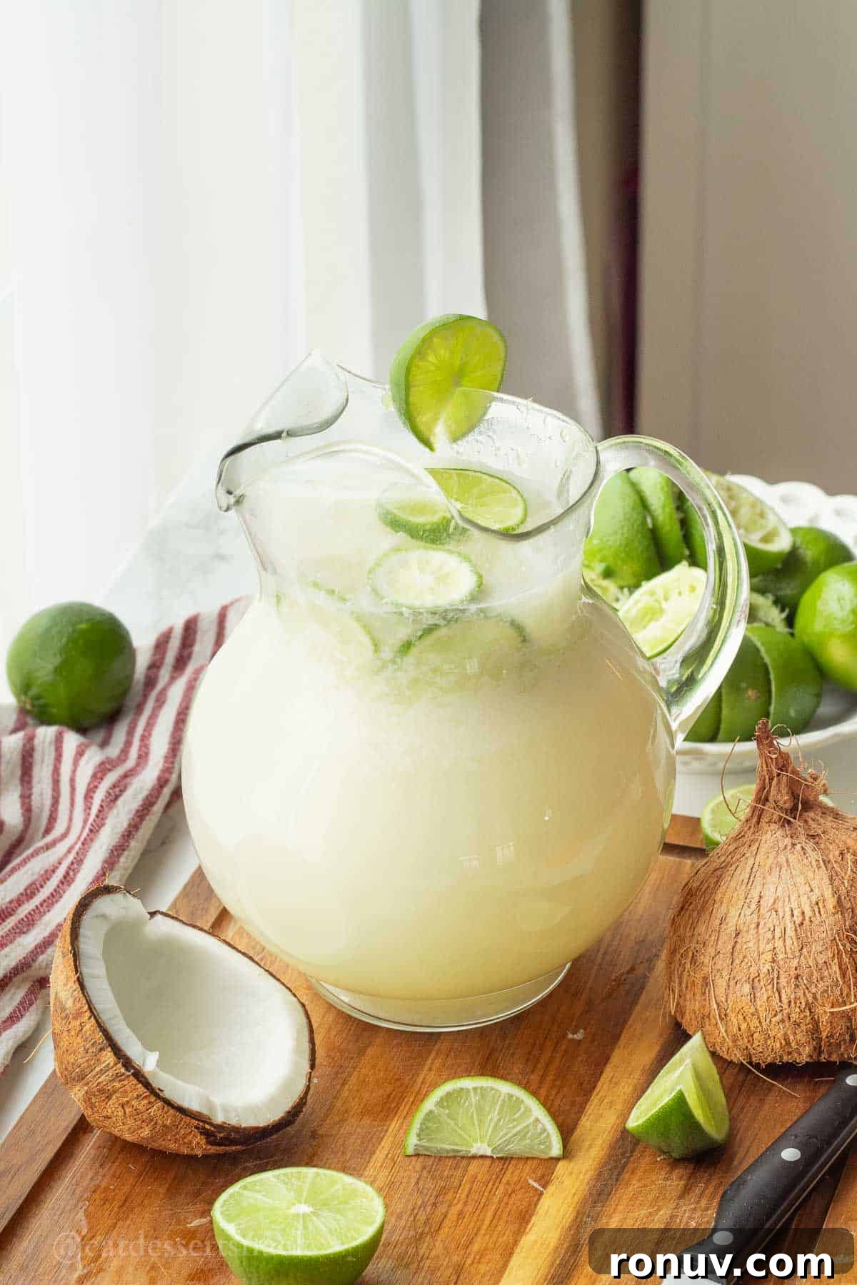 Coconut Lime Cooler: Tropical Drink Recipe 8 Pitcher of lime in the coconut drink.