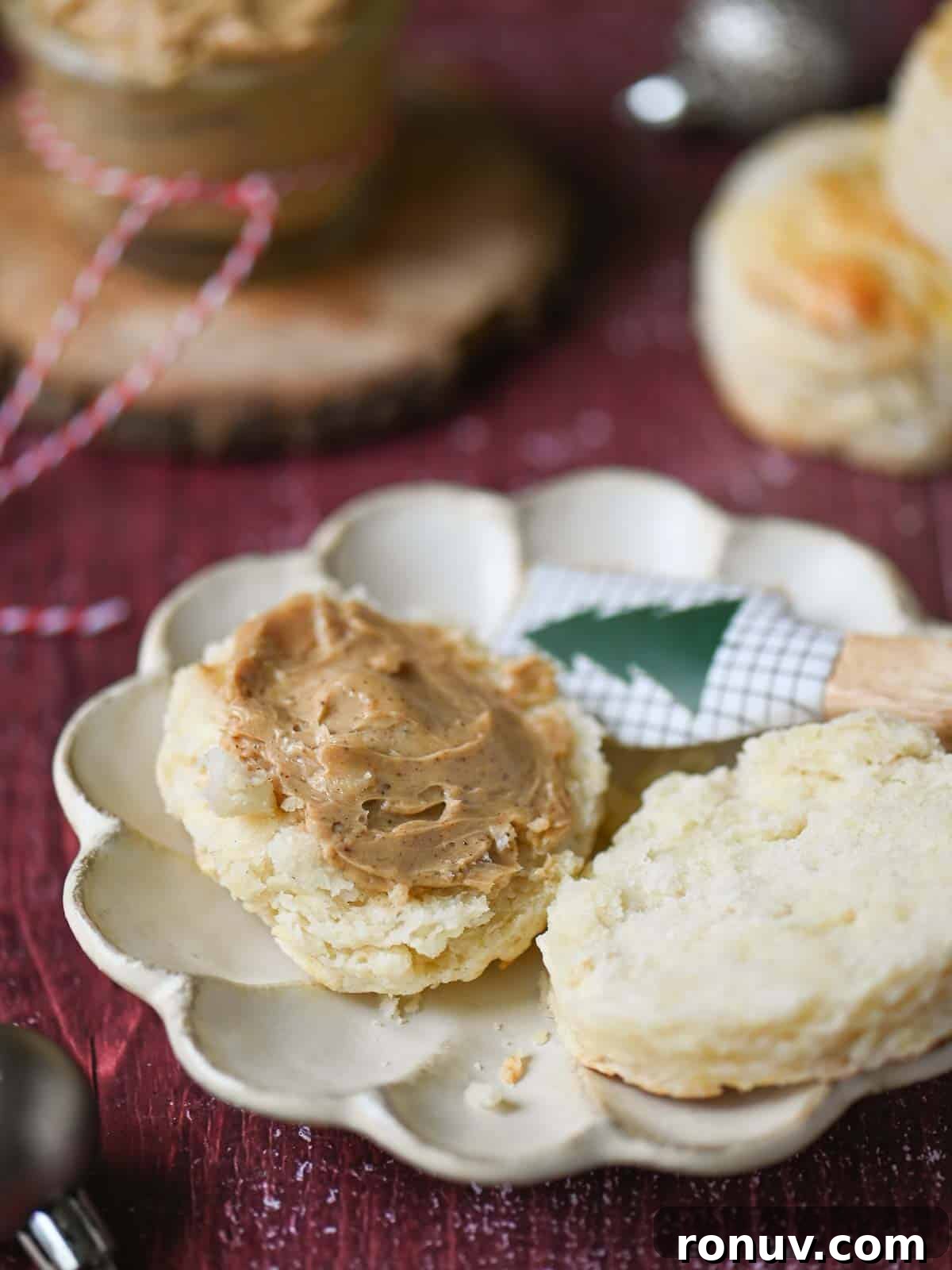 Gingerbread Butter Recipe for the Holidays 8 Gingerbread butter spread on an open biscuit on a red table.
