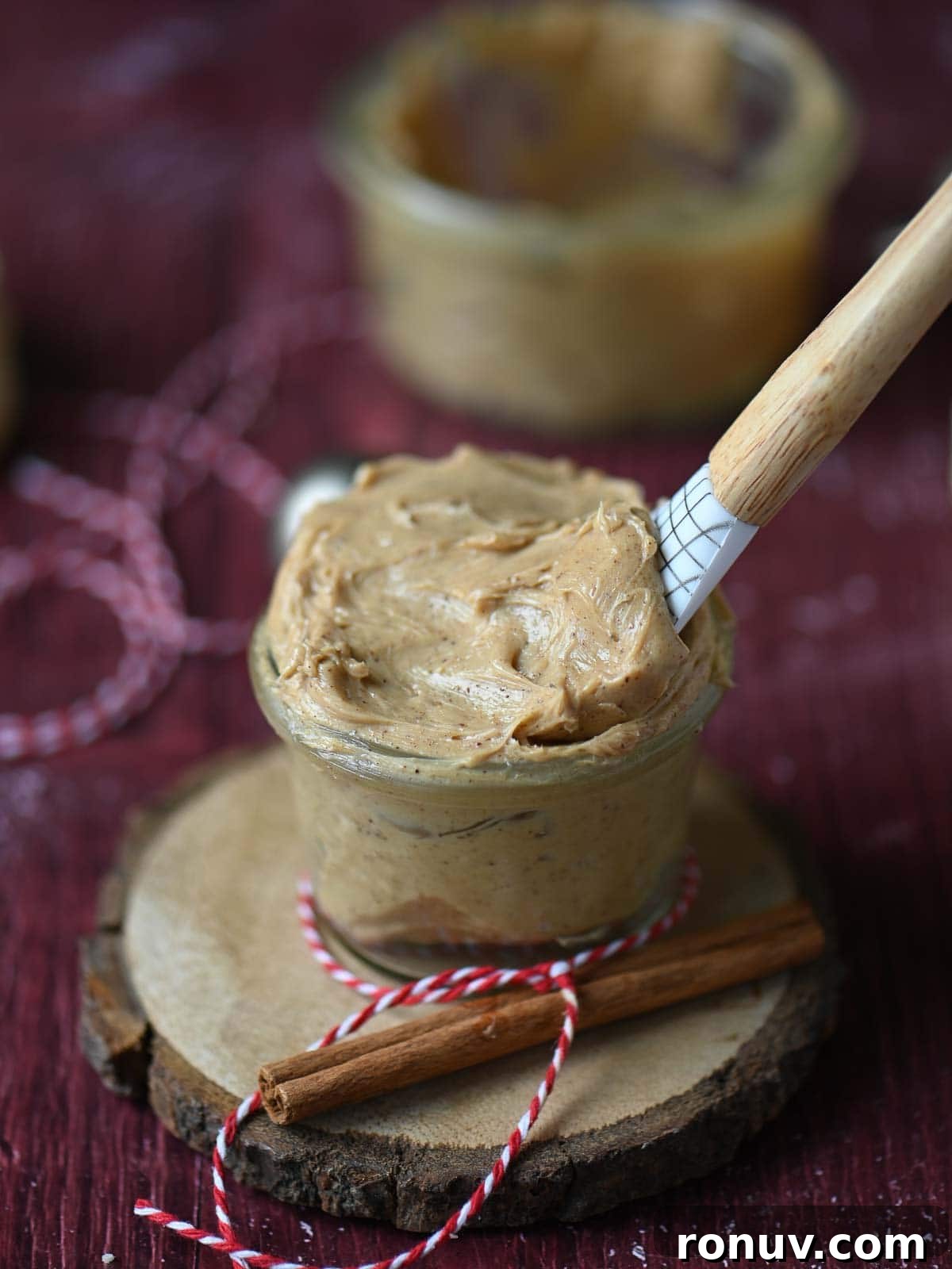 Gingerbread Butter Recipe for the Holidays 9 Creamy butter in a jar with a spatula in it.