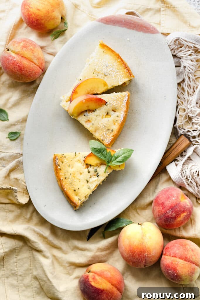 Peach Ricotta Cake with Fresh Basil 3 Three slices of peach cake on an oval plate next to two yellow peaches.