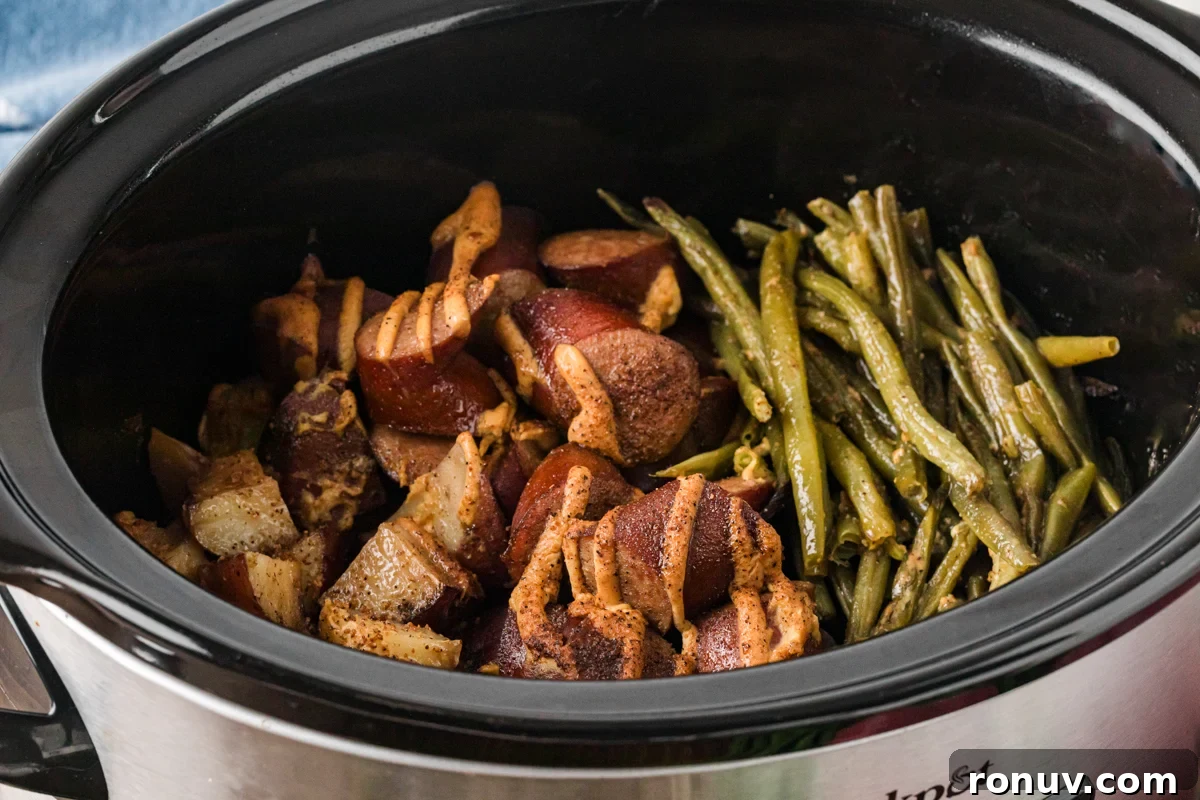 Slow Cooker Kielbasa Dinner Recipe with Potatoes 7 Kielbasa, green beans, and potatoes in a crockpot after cooking.