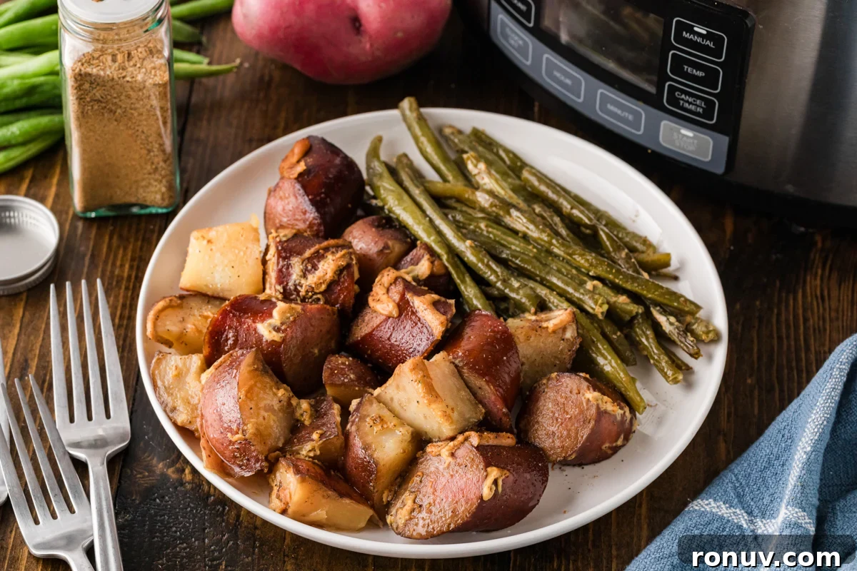 Slow Cooker Kielbasa Dinner Recipe with Potatoes 8 Kielbasa dinner on a white plate.