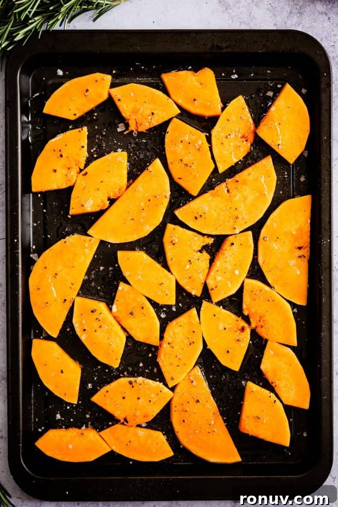 Roasted Butternut Squash and Goat Cheese Tart 6 top view of a baking tray with butternut squash wedges