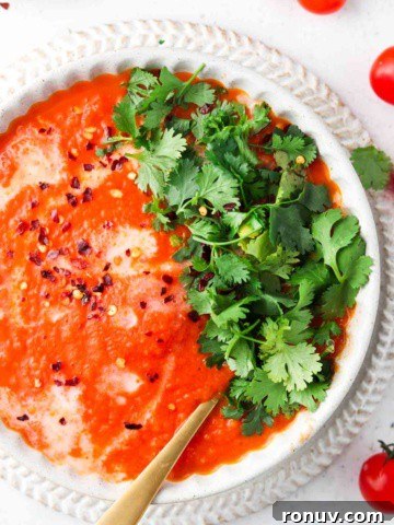overhead shot of red soup in a bowl