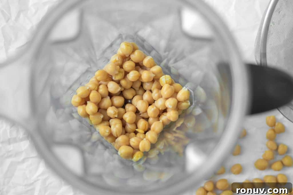 Creamy Homemade Hummus Recipe with Garlic and Lemon 4 chickpeas in a vitamix blender container