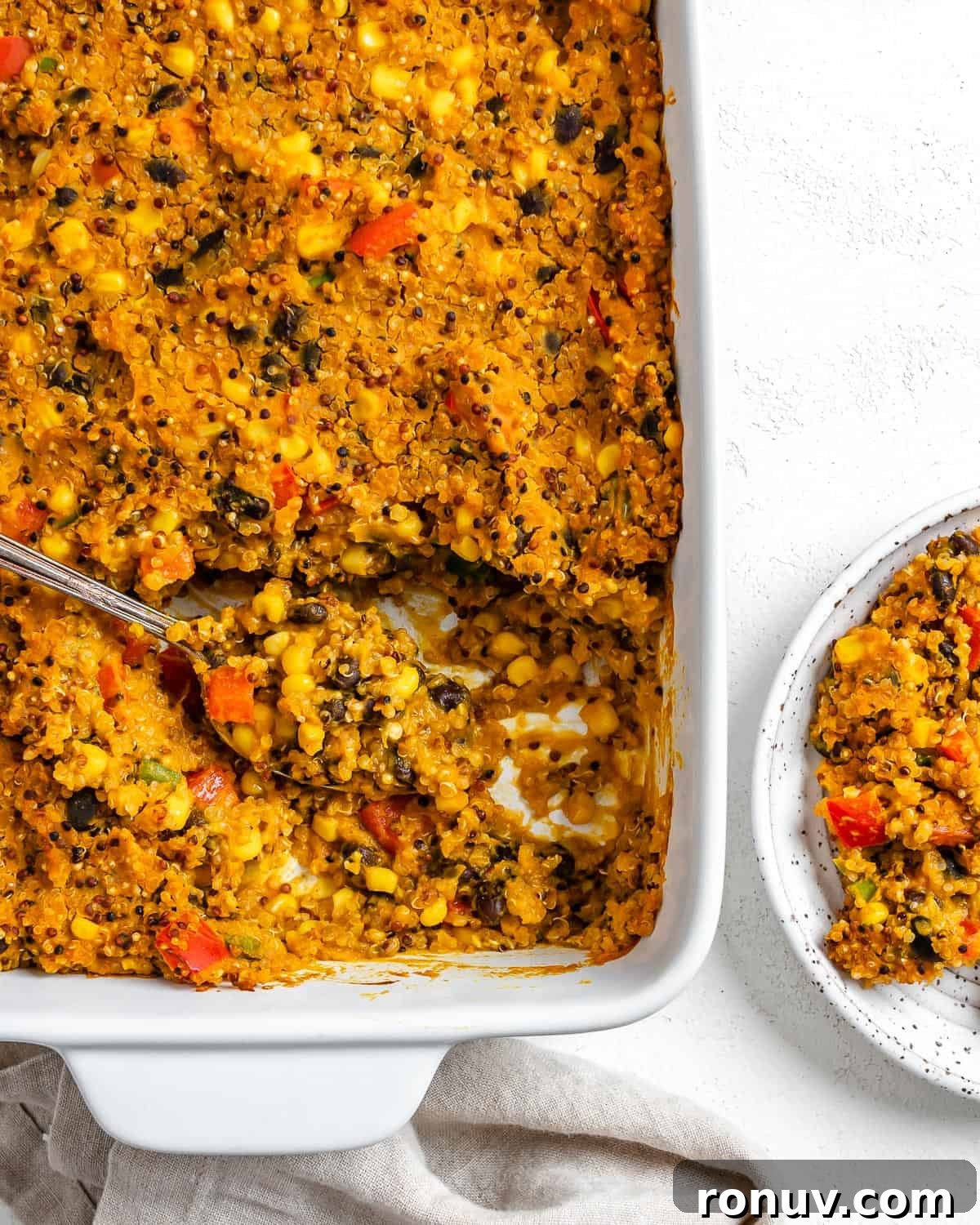 Baked Black Bean and Quinoa Casserole 9 completed Easy Black Bean Quinoa Casserole in a baking dish against a white surface with a serving on a plate