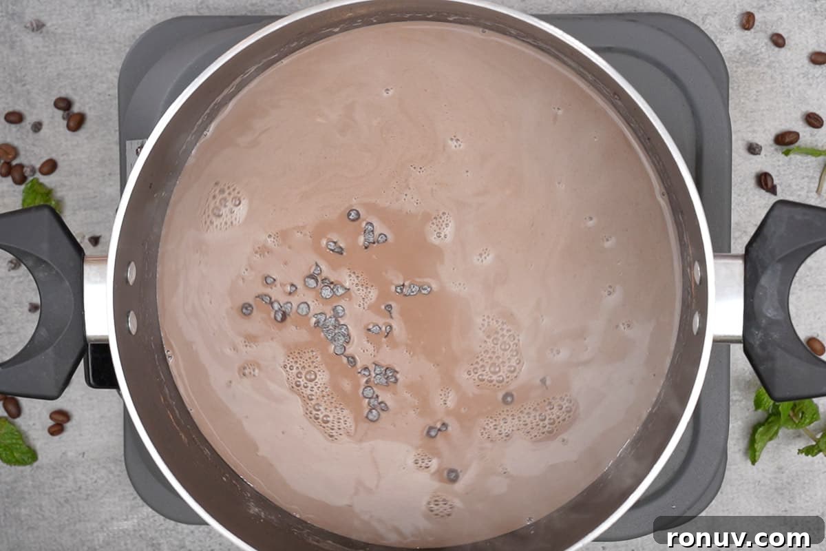 How to Make Espresso Hot Chocolate 6 Chocolate chips, vanilla and espresso added to the pan.
