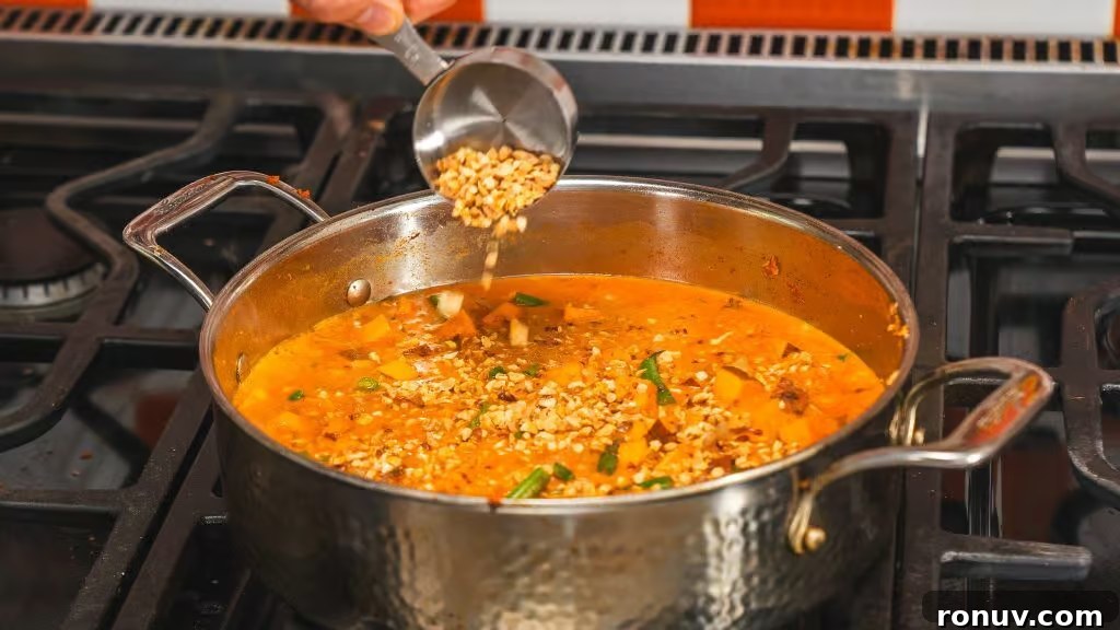 Authentic Thai Massaman Curry: Classic Recipe and Tips 5 Pan of simmering Massaman curry with sweet potato and green beans