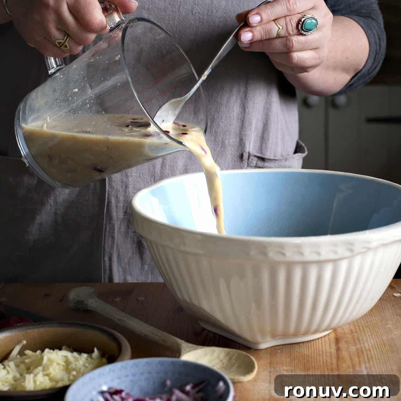 Savory Cheese and Red Onion Muffins: Budget-Friendly Snack 10 Pouring wet into dry ingredients