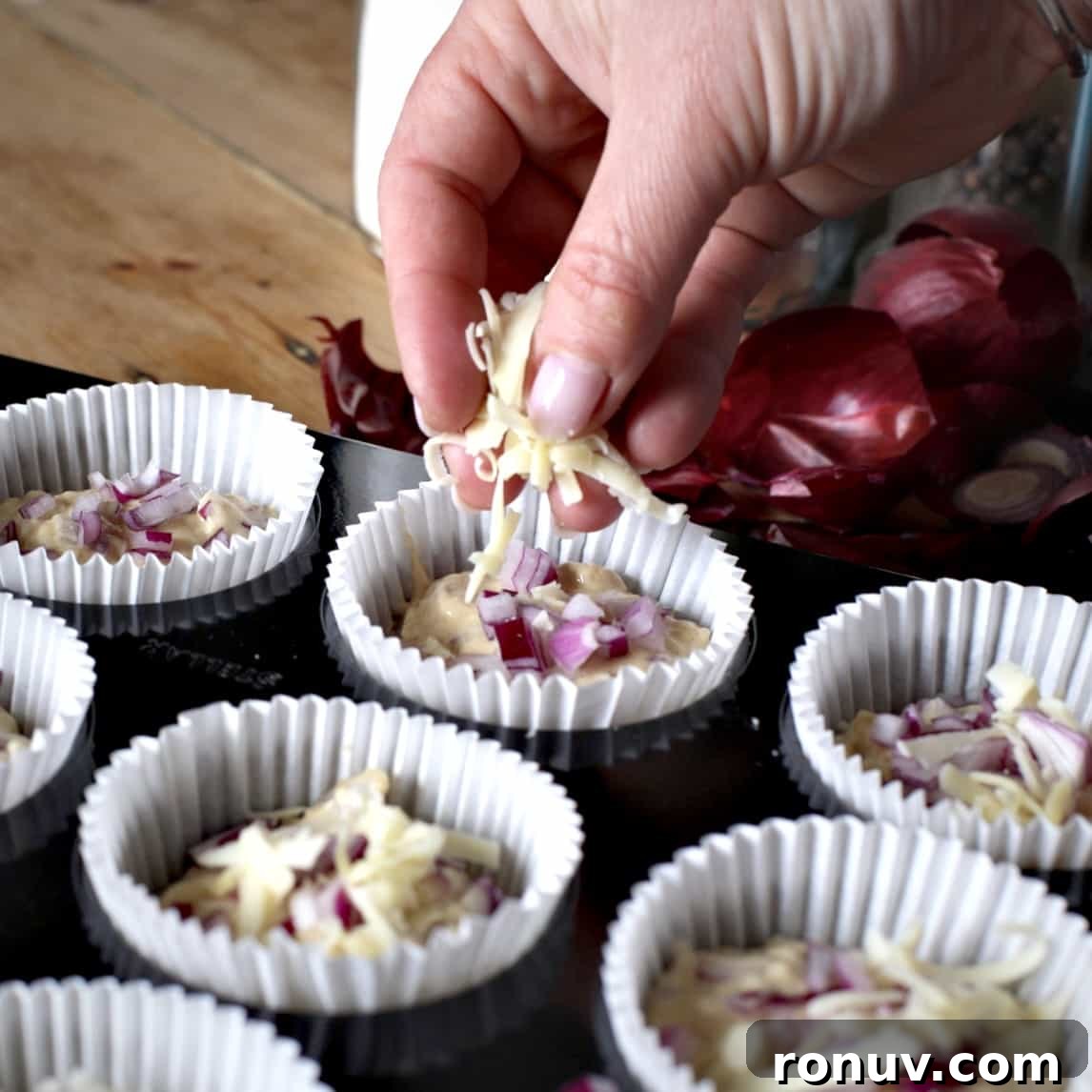 Savory Cheese and Red Onion Muffins: Budget-Friendly Snack 12 Sprinkling cheese over muffins