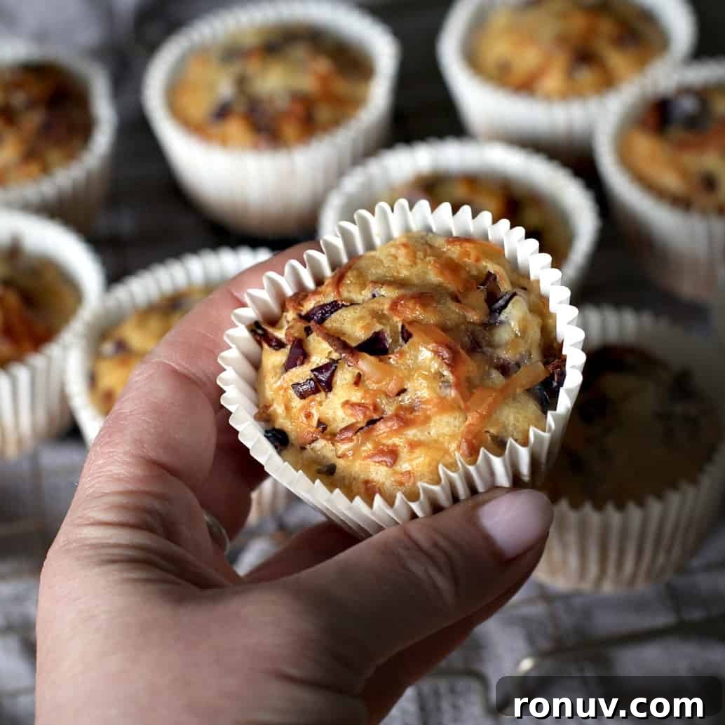 Savory Cheese and Red Onion Muffins: Budget-Friendly Snack 14 Hand holding a cheese and onion muffin