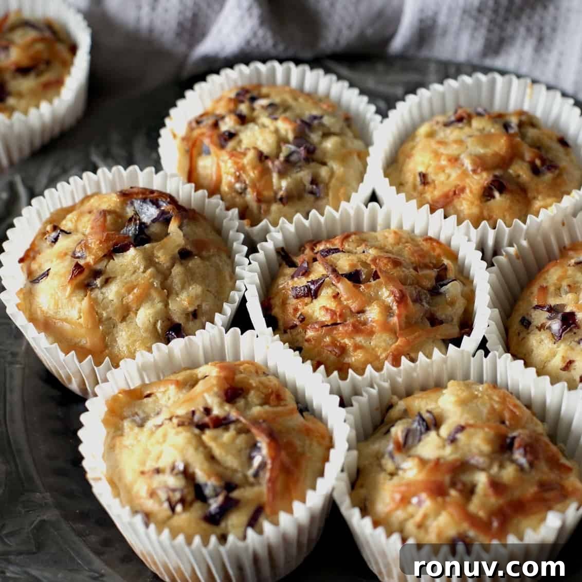 Savory Cheese and Red Onion Muffins: Budget-Friendly Snack 3 8 cheesy muffins on a pewter plate