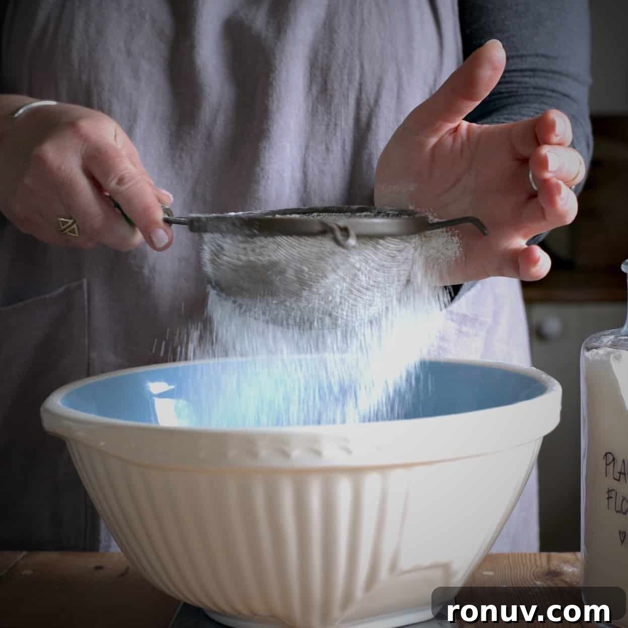 Savory Cheese and Red Onion Muffins: Budget-Friendly Snack 5 Woman sieving flour