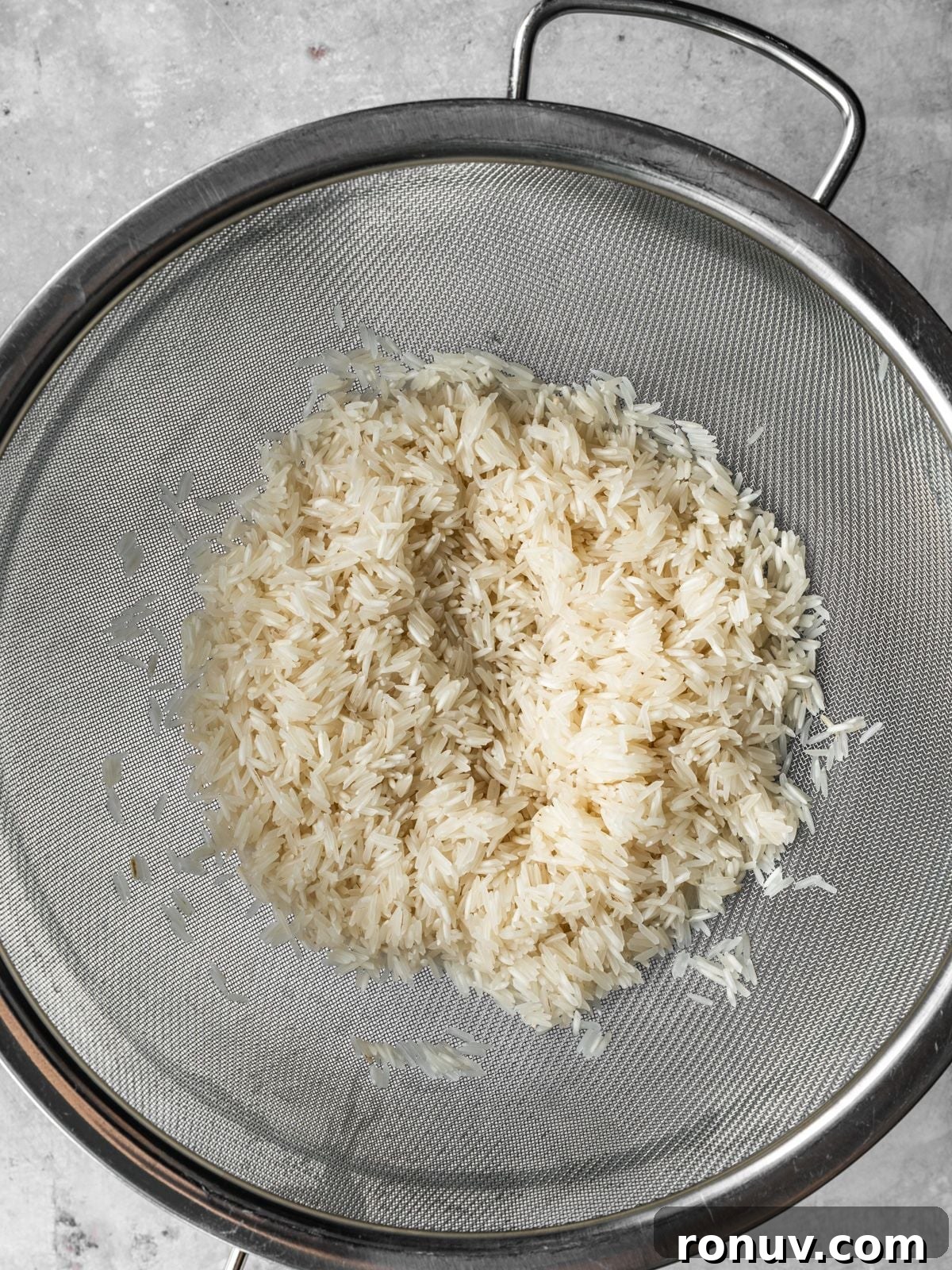 Lebanese Hashweh: Spiced Rice with Ground Beef 4 Basmati rice draining in a sieve.