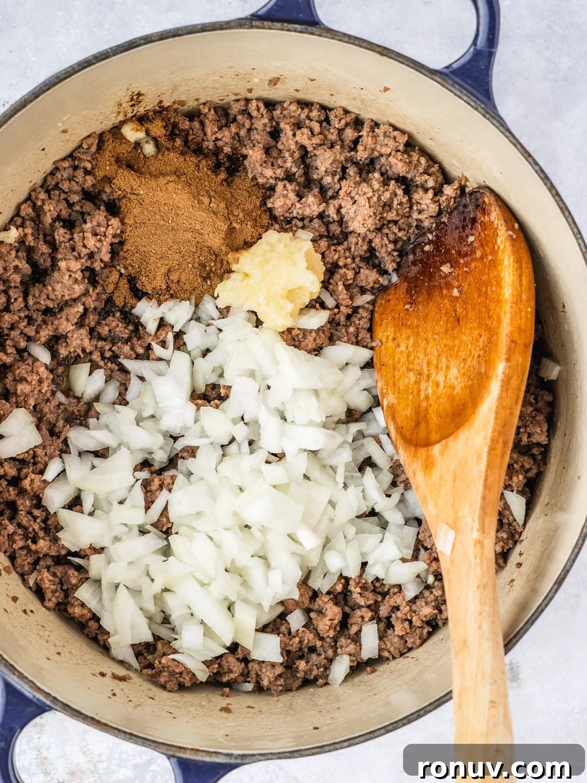 Lebanese Hashweh: Spiced Rice with Ground Beef 6 Adding the spice, garlic and chopped onion to the pot with the cooked beef.