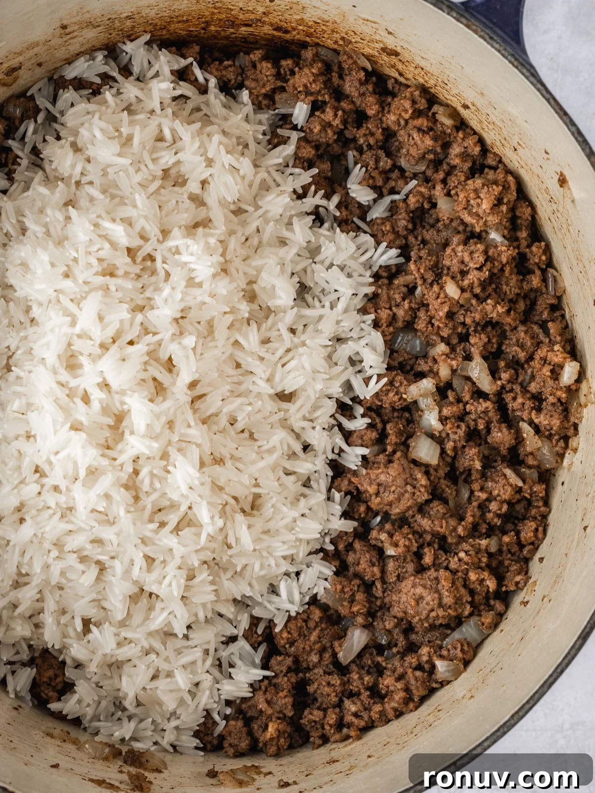 Lebanese Hashweh: Spiced Rice with Ground Beef 7 Adding the washed and drained rice to the cooked ground beef mixture in a pot.