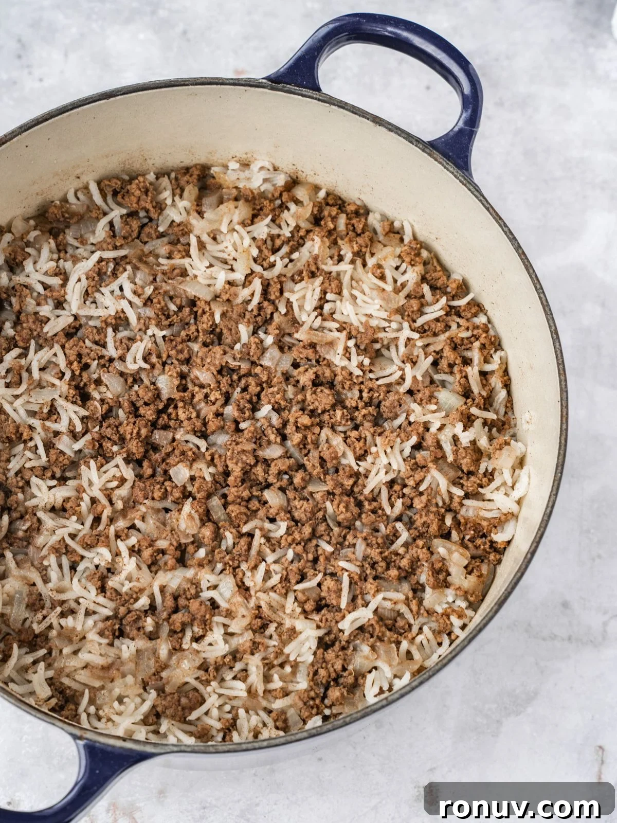 Lebanese Hashweh: Spiced Rice with Ground Beef 9 A pot with cooked rice and ground beef.