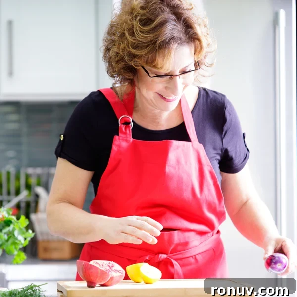 Sangrita: The Secret Behind a Tequila Completo 10 Beth Lee in red apron looking at vegetables on cutting board