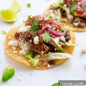 Sangrita: The Secret Behind a Tequila Completo 9 Close up of carnitas taco on a white background.
