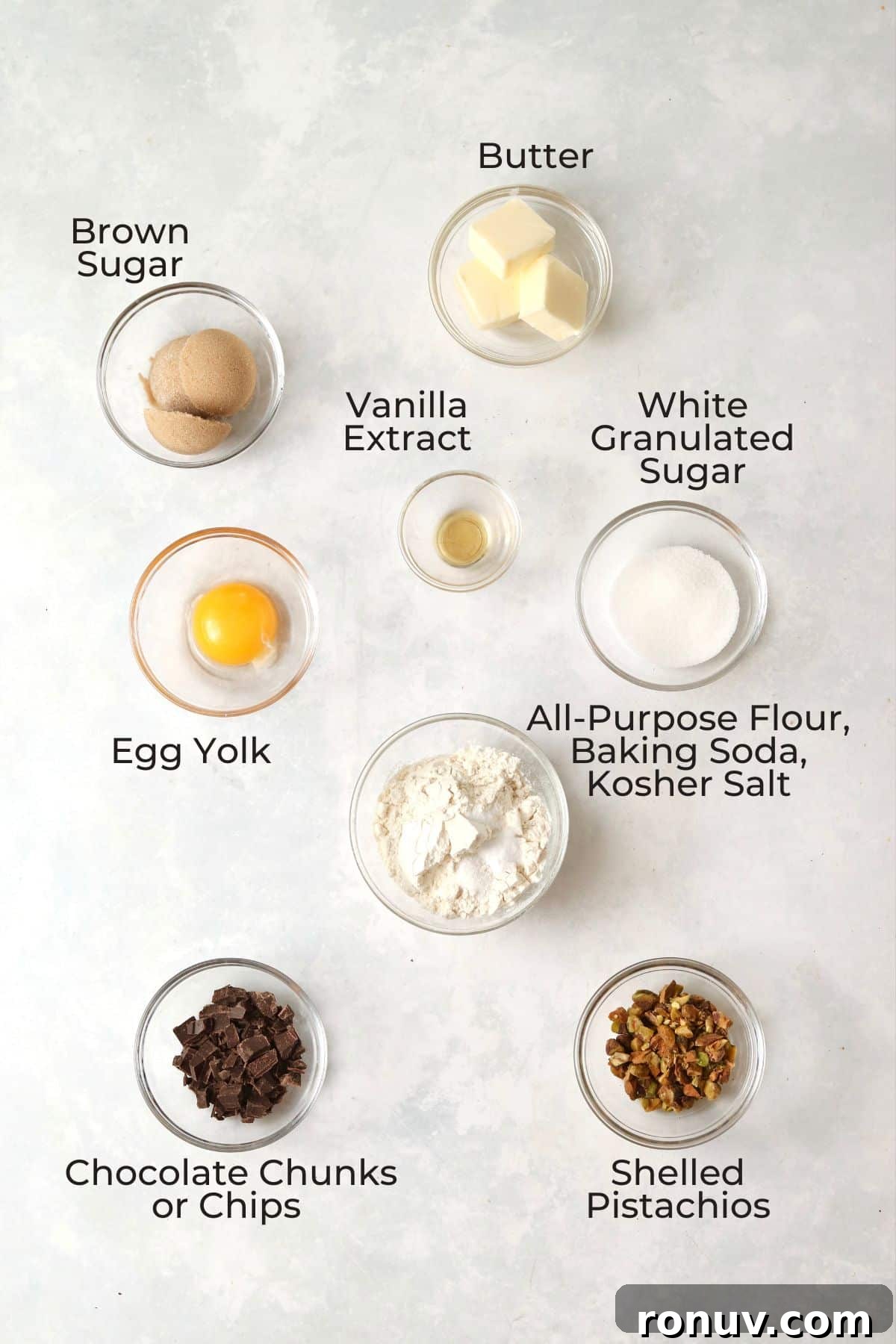 Ingredients to make single serve pistachio chocolate chunk cookies in small prep bowls.