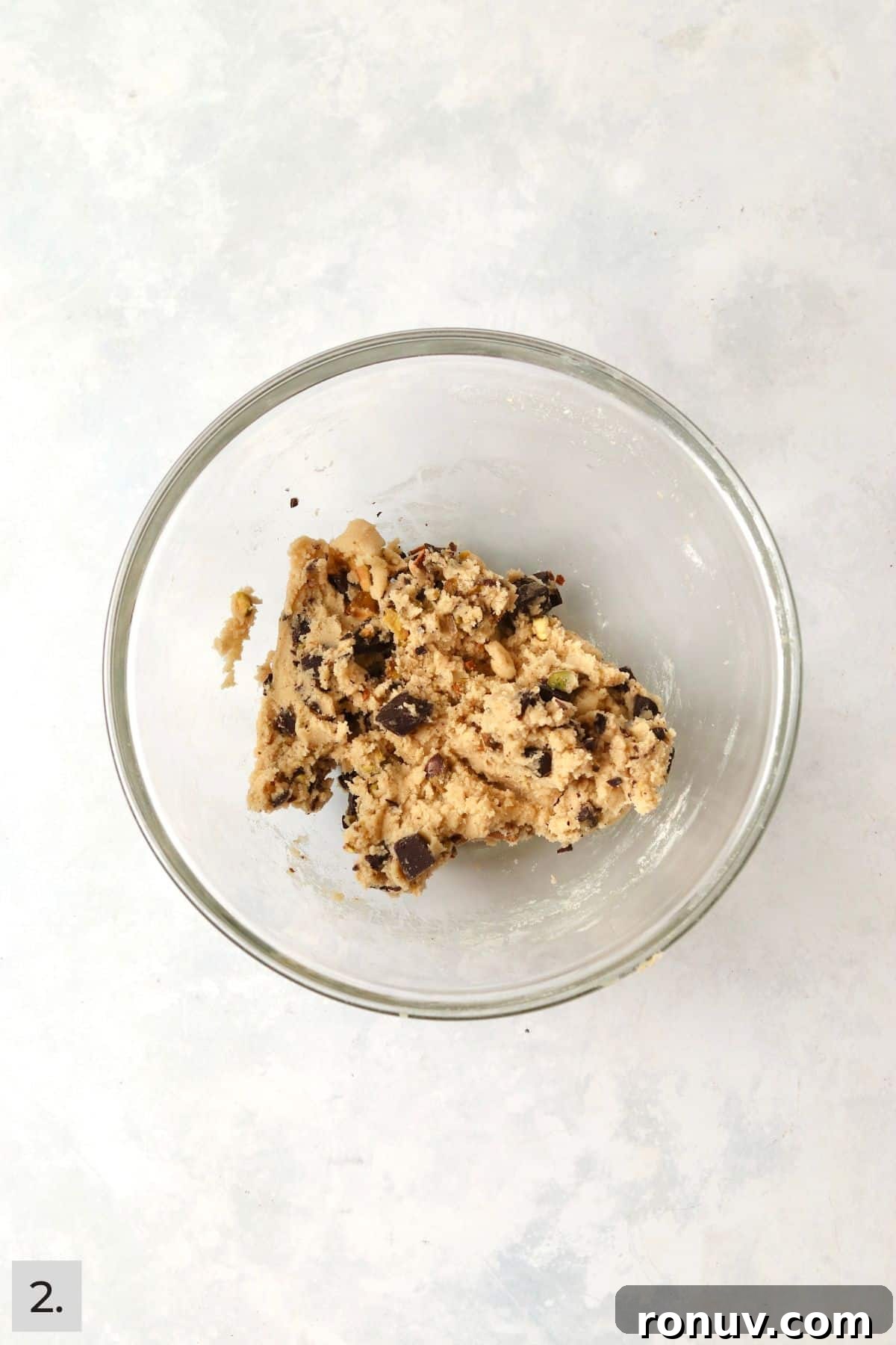 Small batch of pistachio chocolate chunk cookie dough in a mixing bowl.