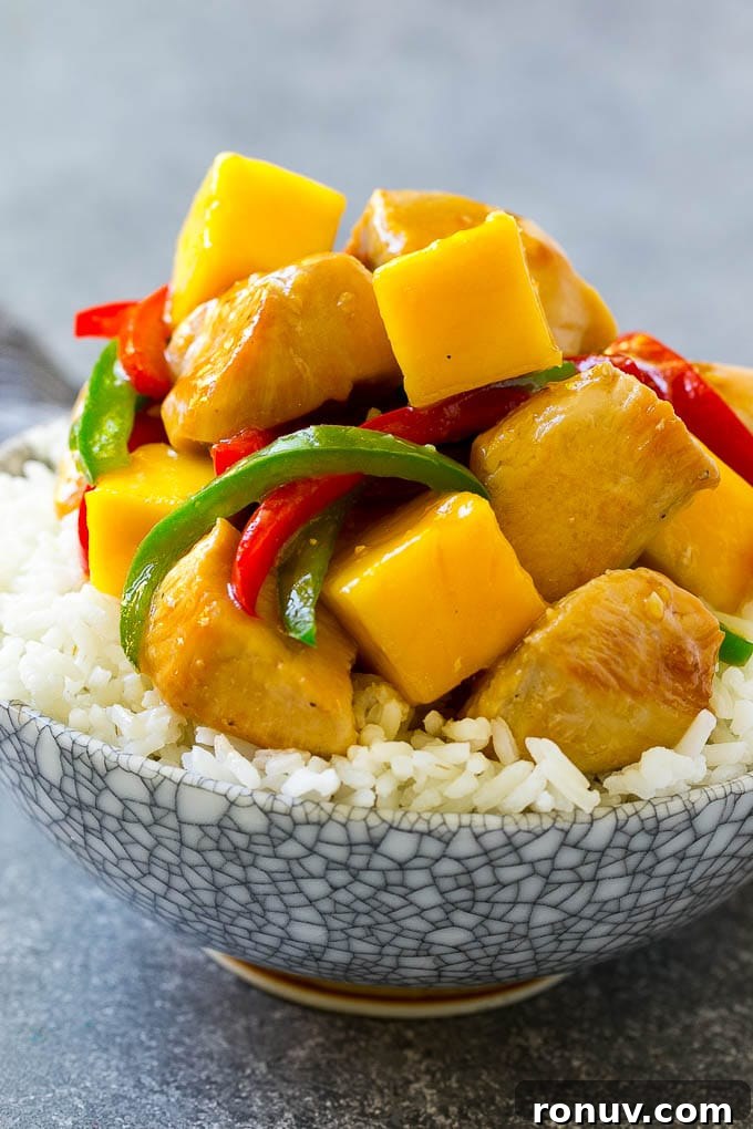 Mango chicken served over rice A bowl of mango chicken served over rice.