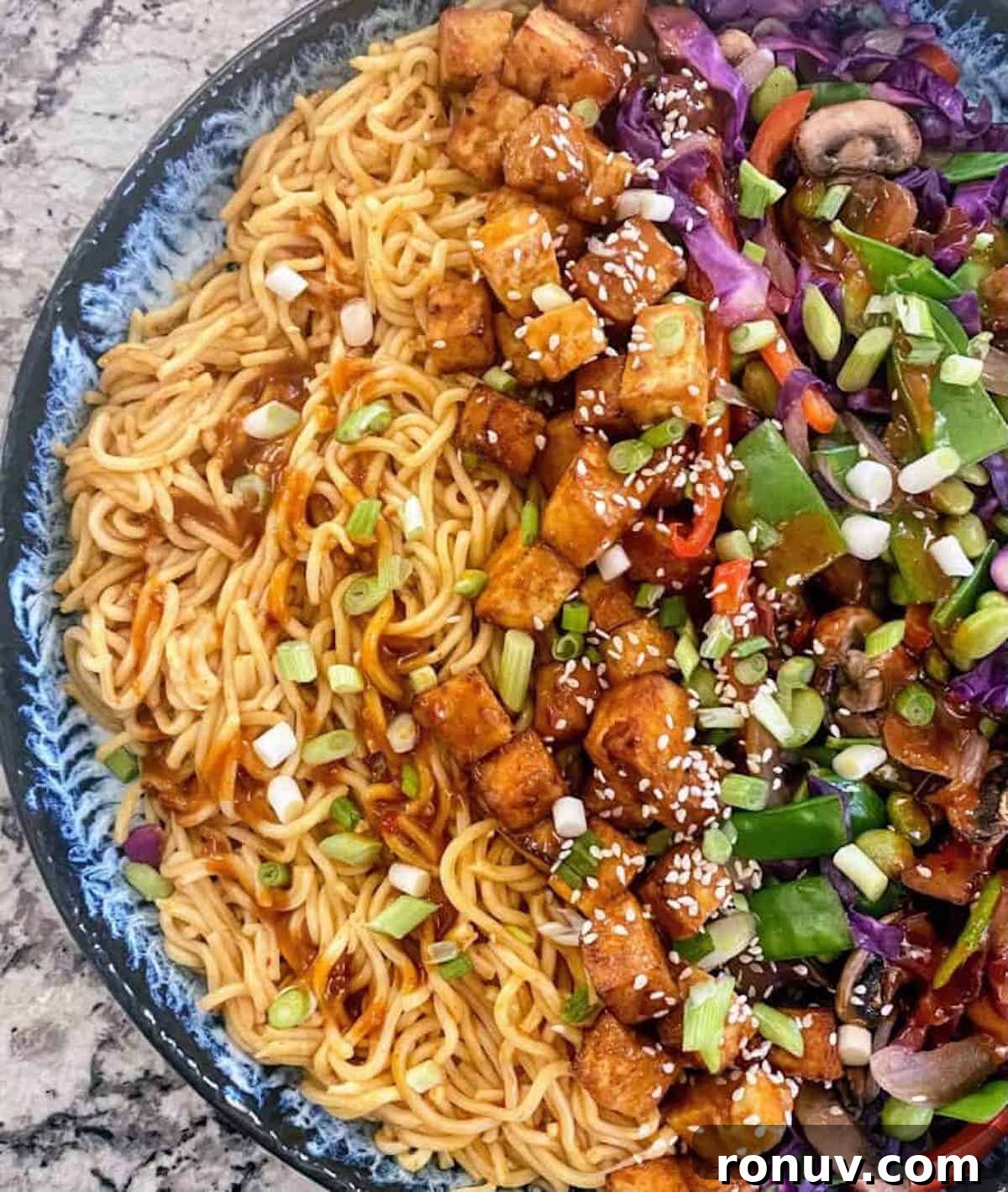 15-Minute Garlic Butter Noodles Recipe 2 Garlic noodles recipe garnished with green onions and sesame seeds.