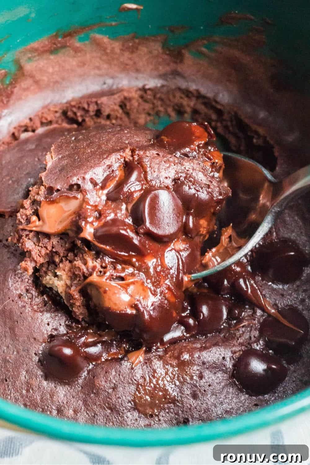 Instant Pot Single-Serve Chocolate Mug Cake 3 a spoon removes a bite of chocolate mug cake that was cooked without a microwave, using the Instant Pot