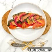 Toasted bread with cream cheese topped with herb-cured salmon and pickled onion.