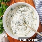 A bowl of chimichurri aioli with a gold spoon.