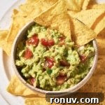 A bowl of 4-ingredient guacamole with tortilla chips.