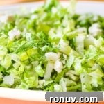 Closeup side view shot of Prasini salad in a white dish.