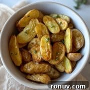Air Fryer roasted fingerling potatoes dressed in olive oil, lemon juice, garlic, and thyme dressing.