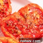 Air fryer tomatoes on a white plate.