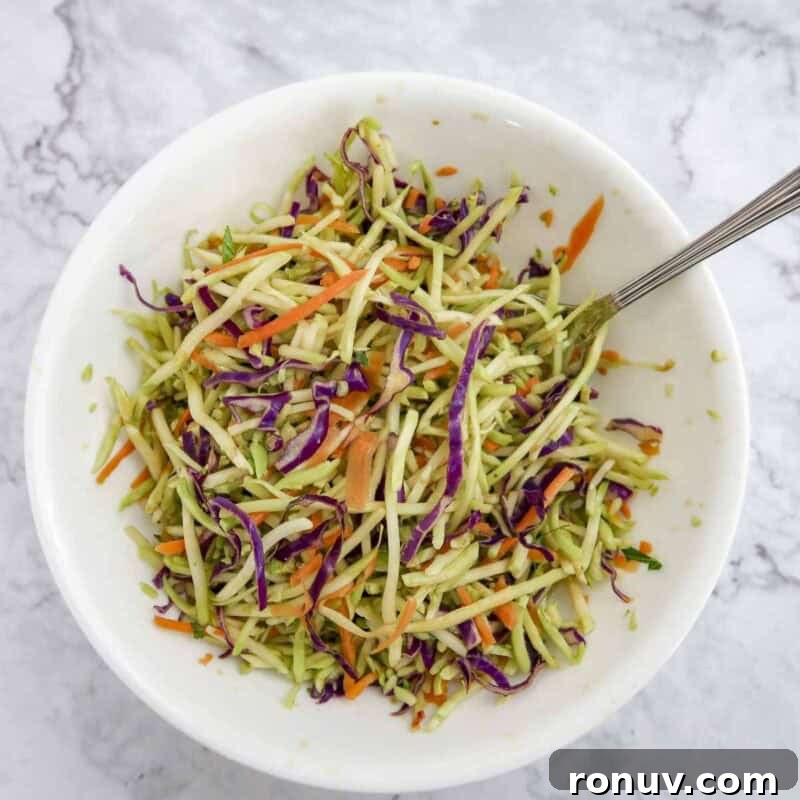 Thai Turkey Burgers with Sweet Chili Glaze 11 Overhead view of slaw process shot 1 - combine the broccoli slaw, lime juice, rice wine vinegar, and soy sauce in a medium bowl to make the slaw.