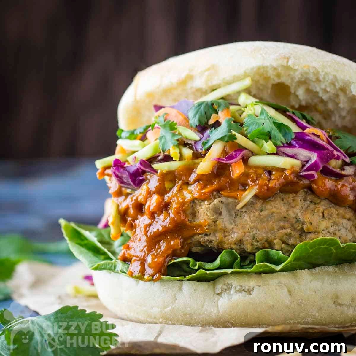 Thai Turkey Burgers with Sweet Chili Glaze 13 Side close up shot of thai turkey burger garnished with fresh parsley.