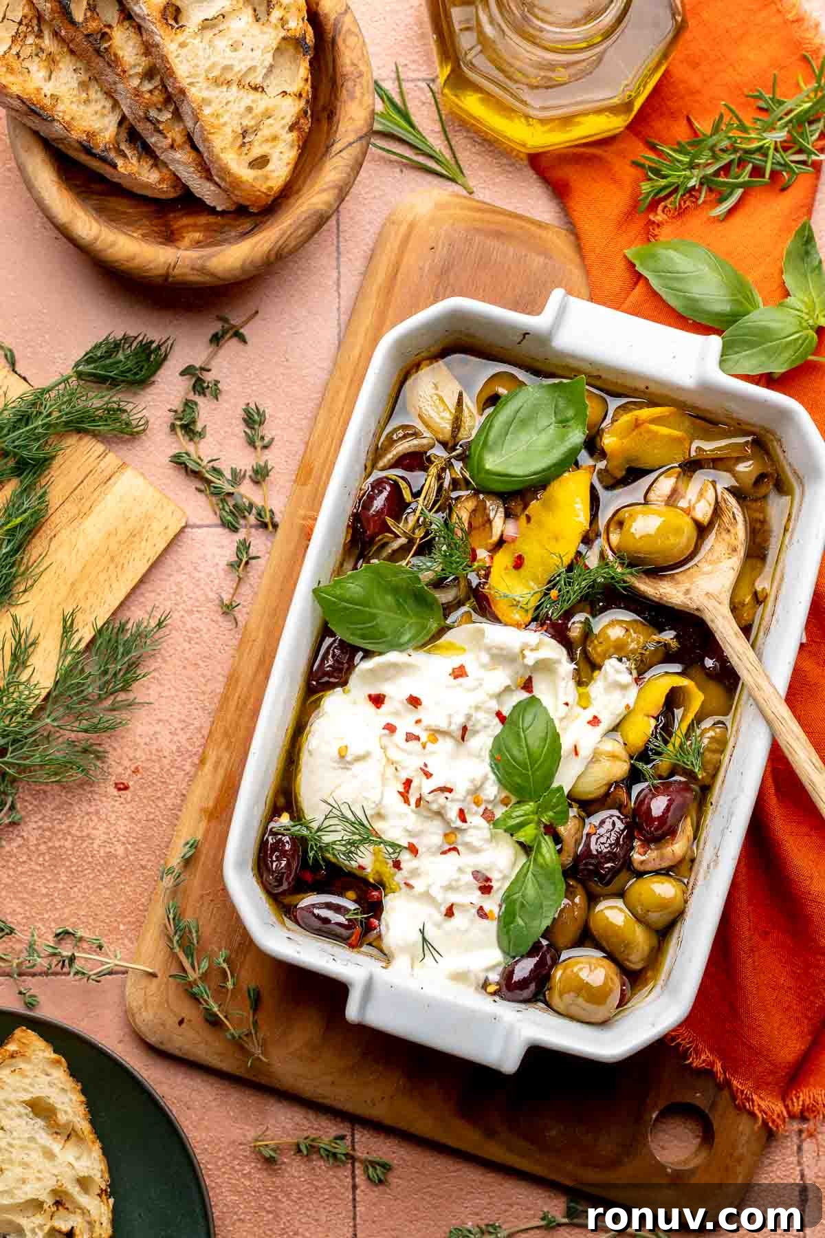 Herb Roasted Olives with Burrata Recipe 2 Roasted olives and burrata in a baking dish.