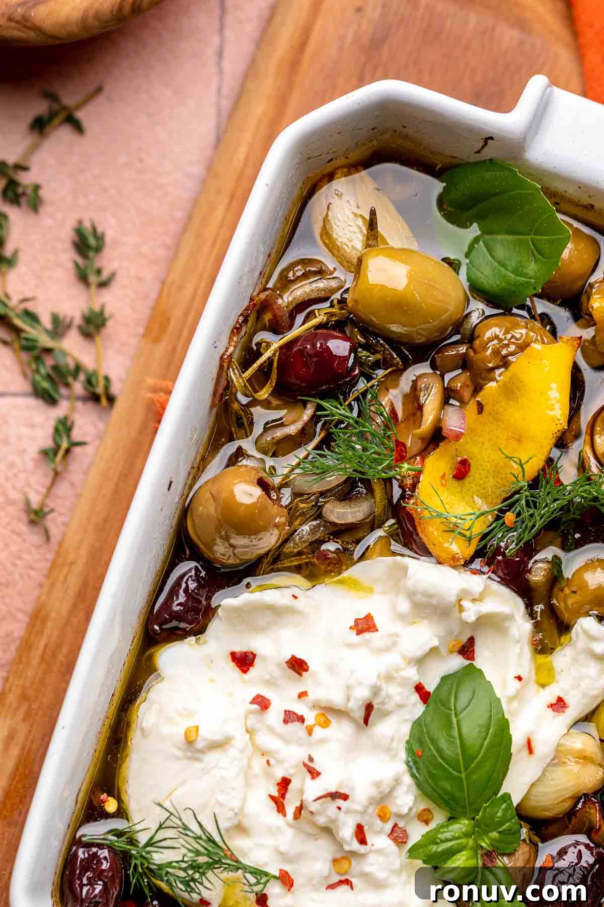 Herb Roasted Olives with Burrata Recipe 9 Burrata nested into baked olives.