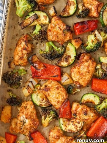Creamy Boursin Spaghetti Squash Recipe 11 An air fryer tray filled with chicken pieces and vegetables.