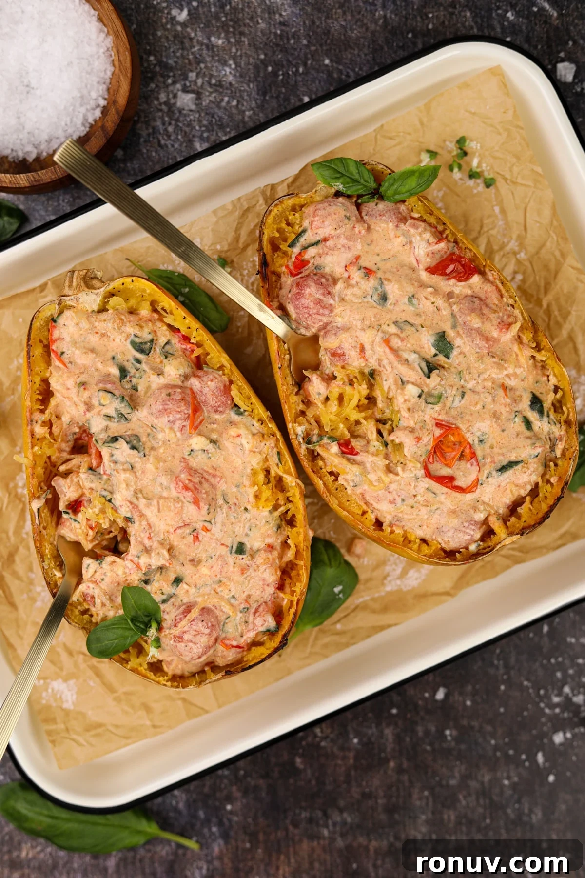 Creamy Boursin Spaghetti Squash Recipe 5 Two Boursin stuffed spaghetti squash halves with forks inside of them.