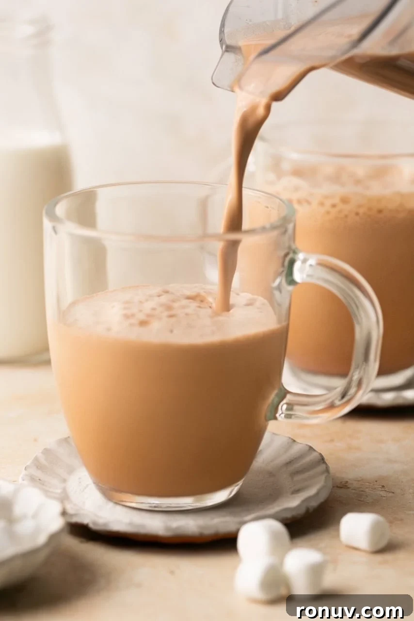 hot chocolate being poured into a mug