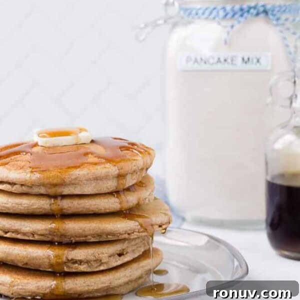 Image of a stack of pancakes with homemade pancake mix in the background.