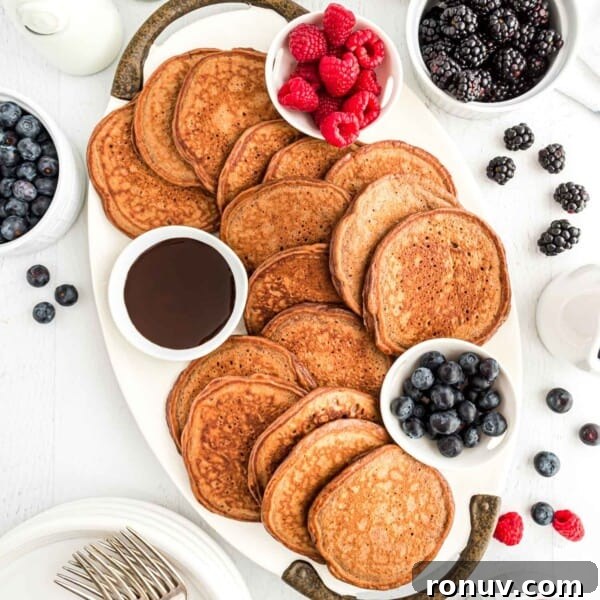 Chocolate protein pancakes spread out on a platter.