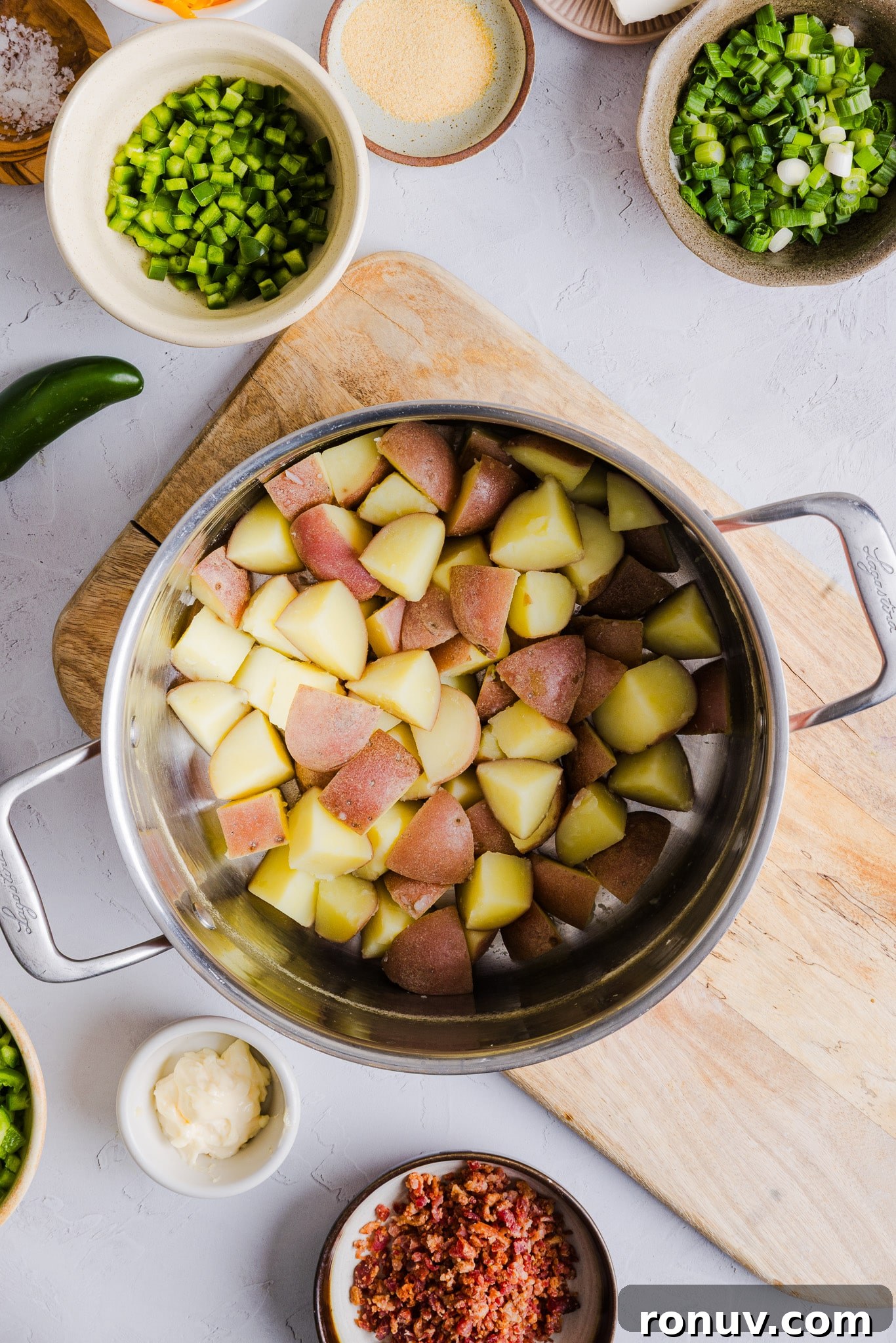Creamy Jalapeño Popper Potato Salad with Bacon and Cheddar 4 Cooked and drained diced potatoes in a pot.
